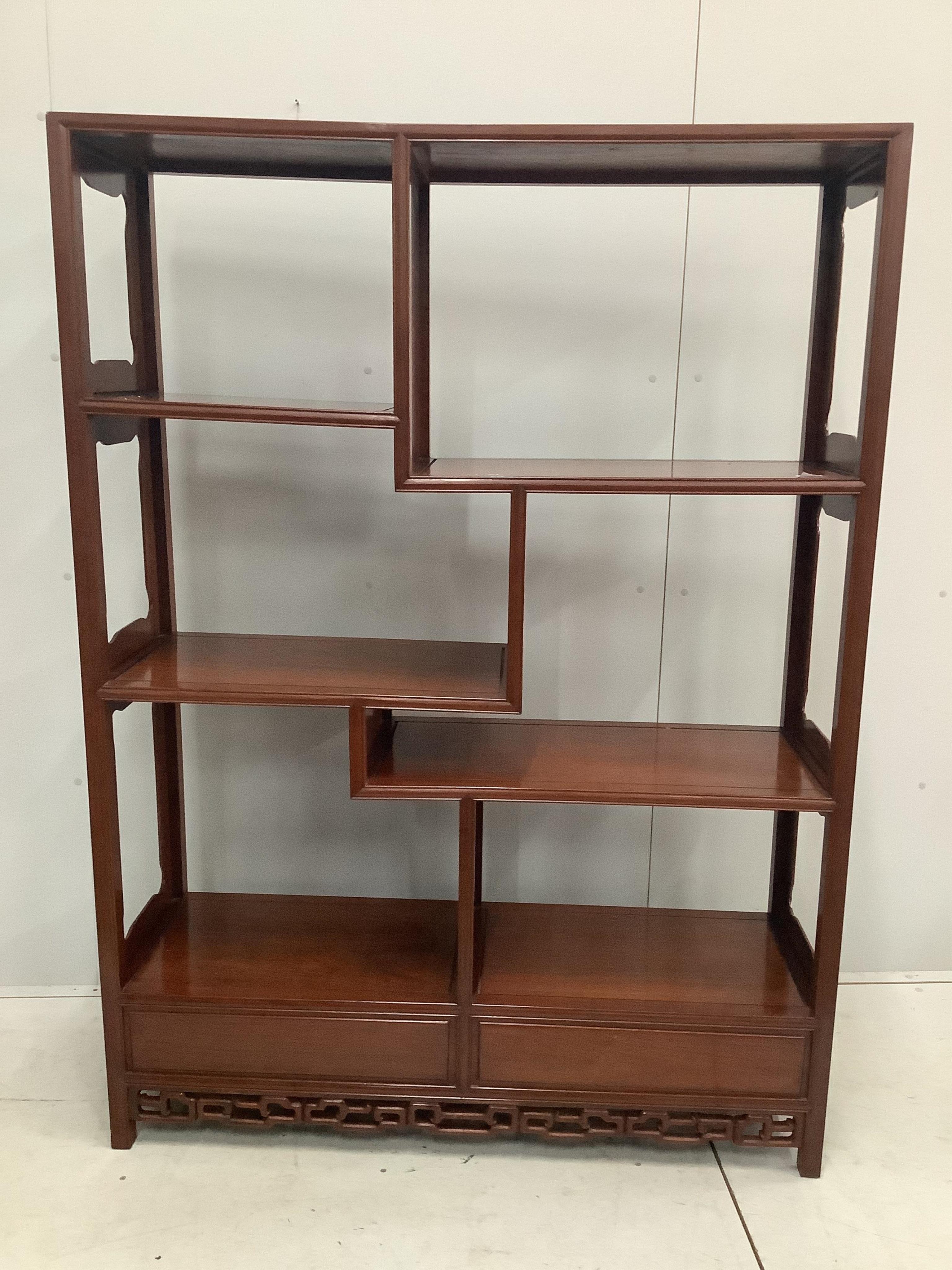 A Chinese padouk wood open shelves unit, width 132cm, depth 39cm, height 168cm. Condition - good